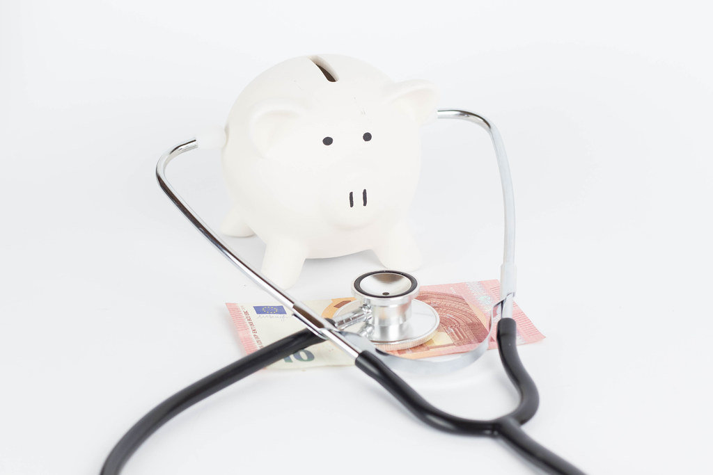 Piggy bank and stethoscope Isolated on a white background