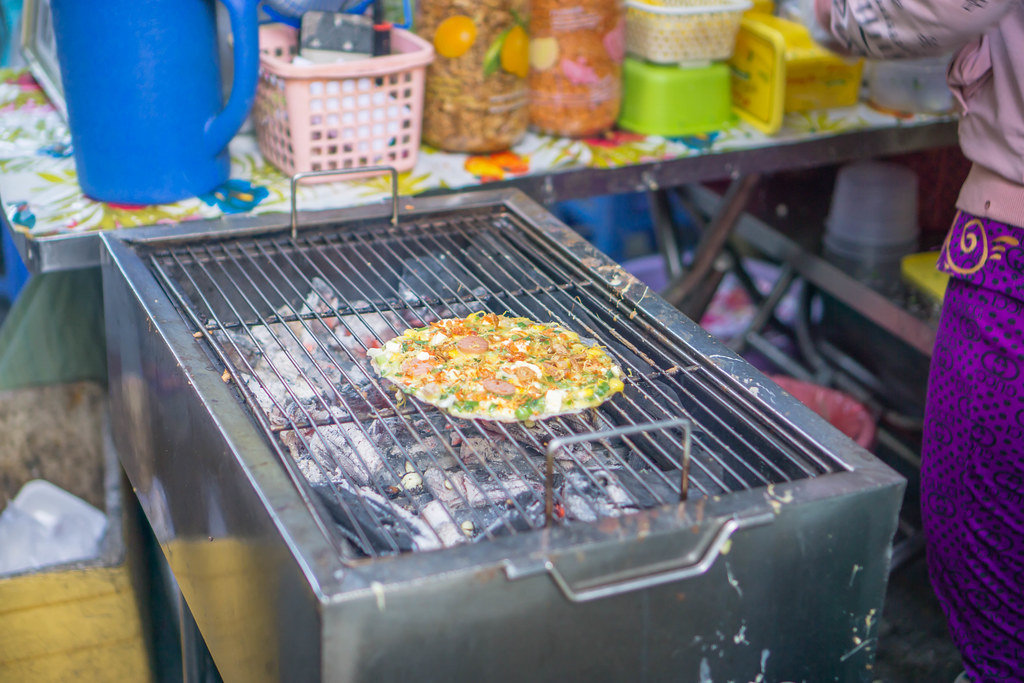 Grilled Rice Paper with Egg and Sausage at Market in Saigon