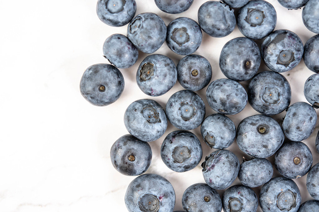 Flat lay above Fresh Blueberries on the white background