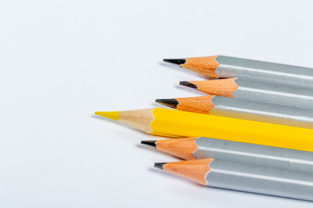 Concept leadership, think different, business success. All gray pencils, and one yellow on white background