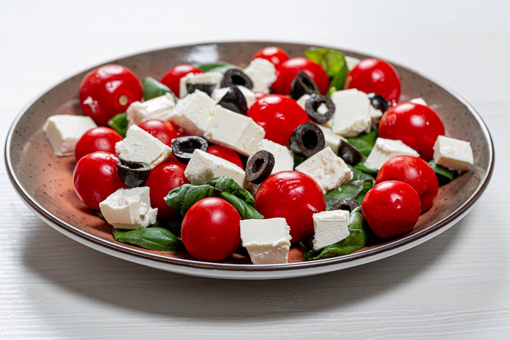 Fresh diet salad with olives, Basil, tomatoes and feta cheese