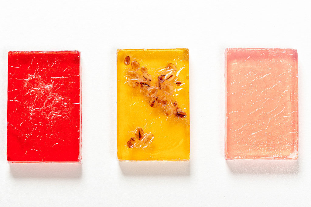 Bars of handmade soap with natural oils on white background. Top view