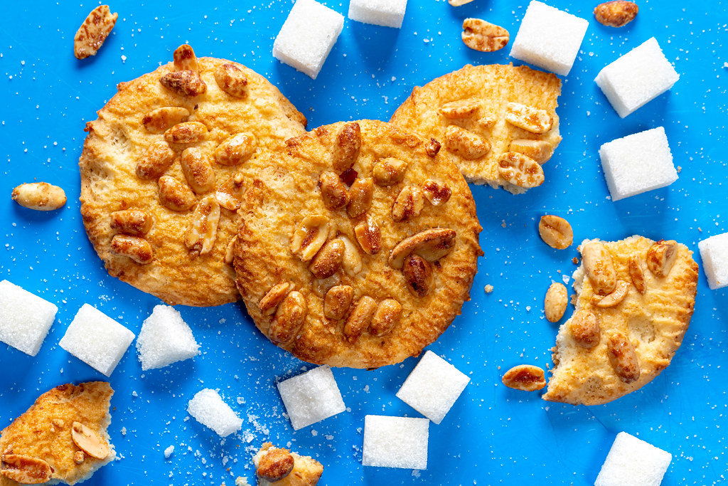 Top view, cookies with peanuts and sugar cubes on a blue background
