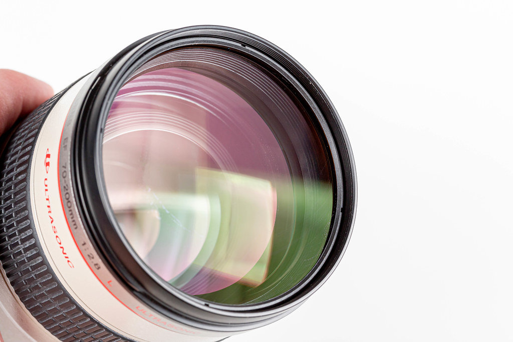 Close-up camera lens on white background
