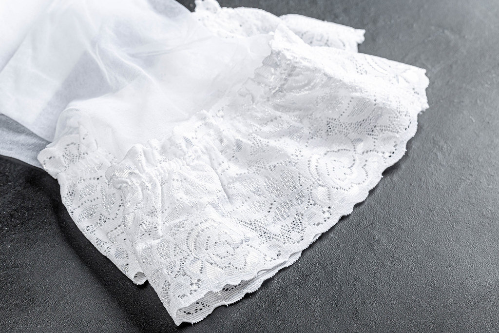 Close-up of white womens stockings on a black background