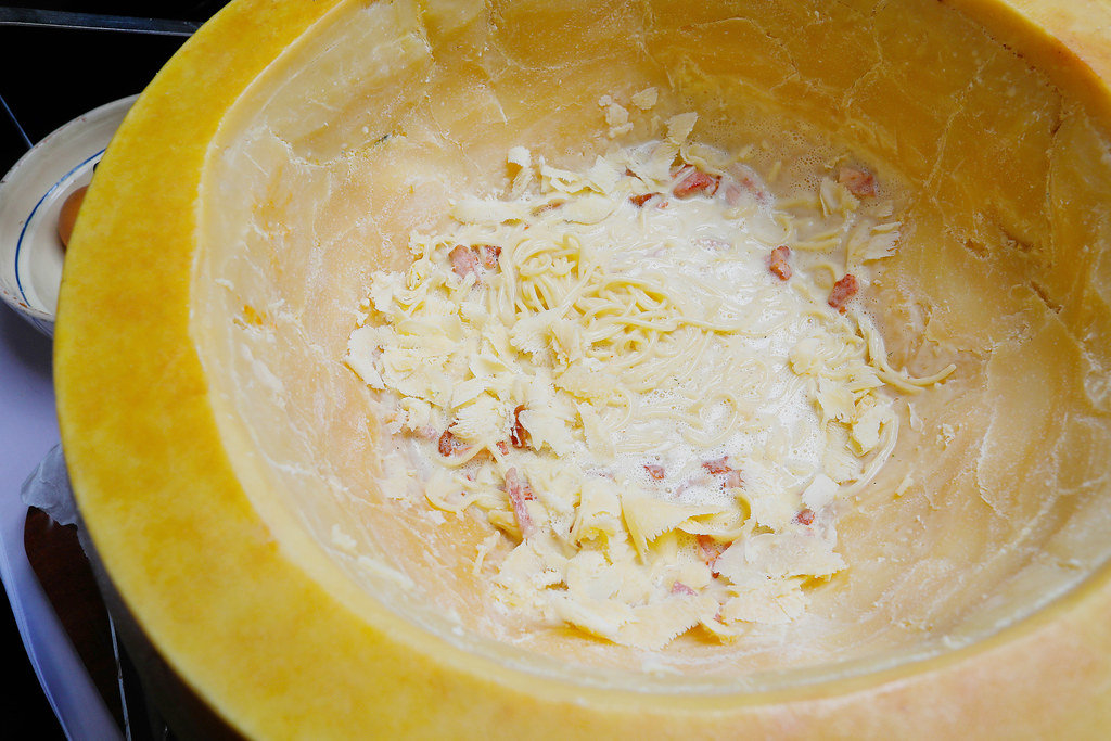 Spaghetti with bacon in parmesan cheese wheel ready to be served. Italian cuisine