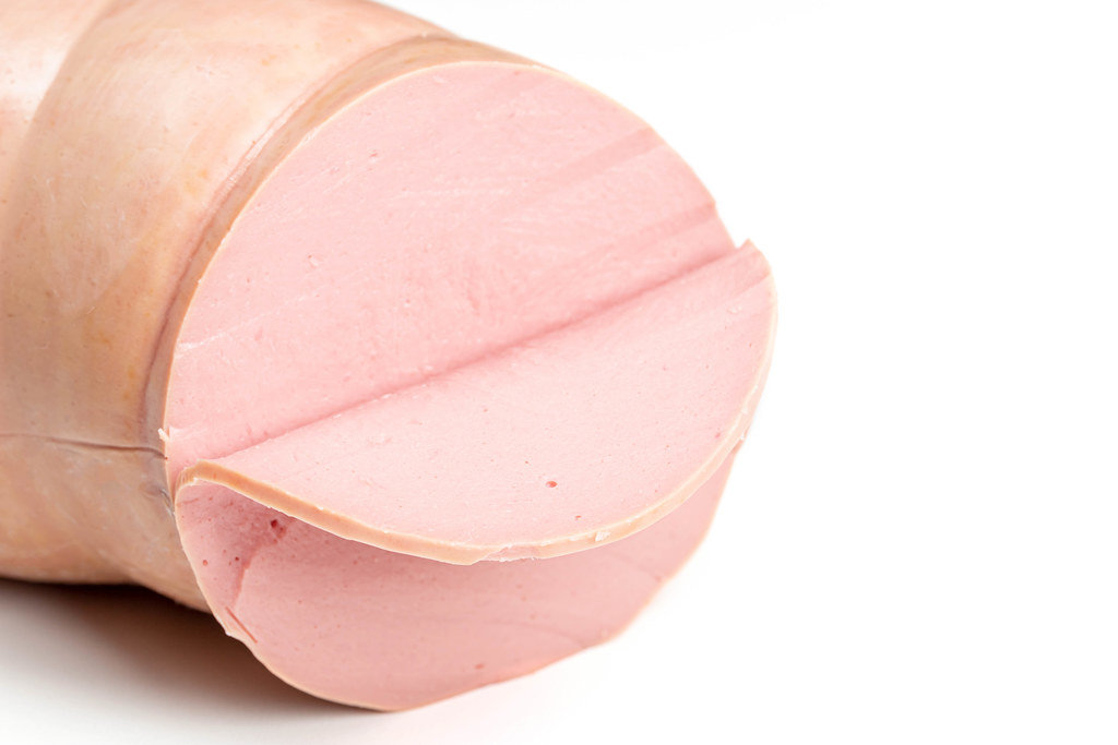 Close up of boiled sausage on white background