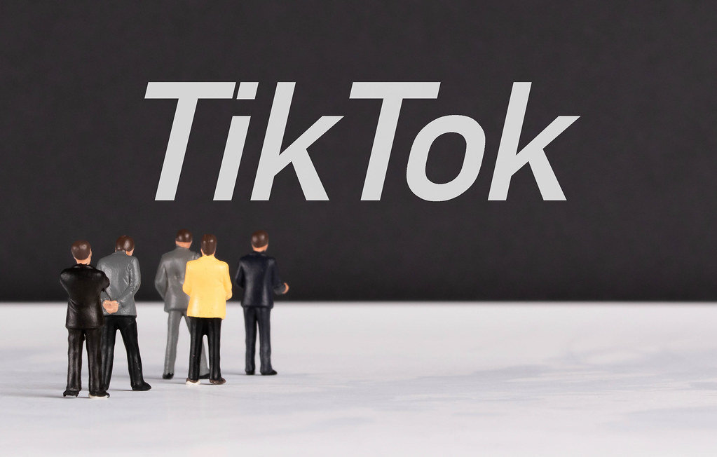 People standing in front of TikTok text