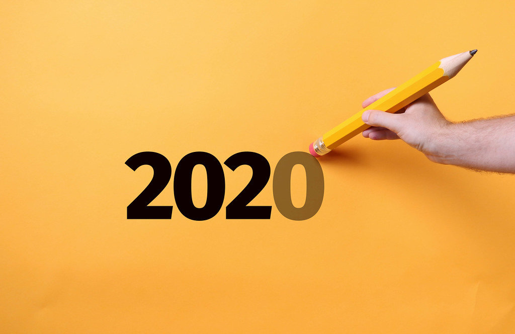Pencil erasing zero from 2020 text