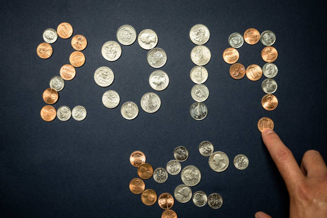 Hands completing 2019 formed with coins