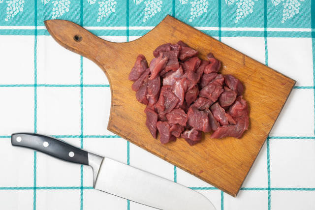 Flat lay above sliced beef meat on the cutting board