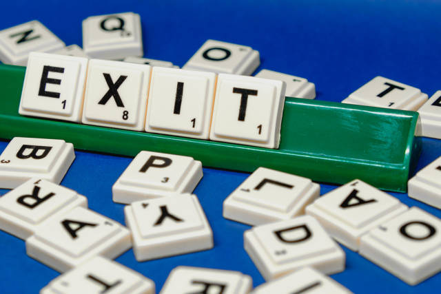 Close up shot of Exit word formed from scrabble