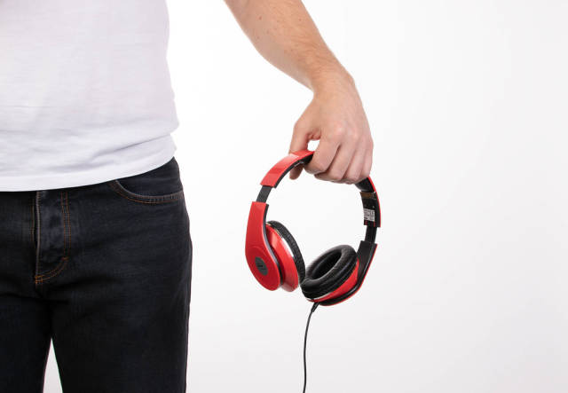 Man holding red headphones