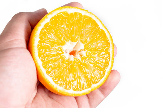 Sliced Half Orange fruit in the hand