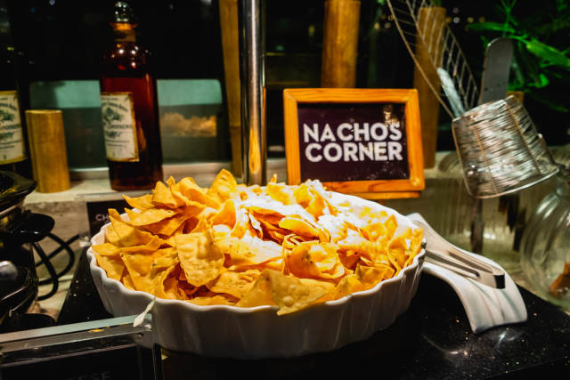Fried nachos in white bowl on display