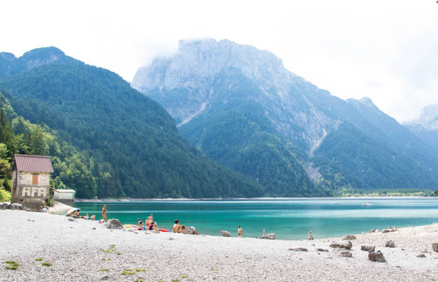 Lake Predil with turquoise water and mountains in background near Tarvisio in European Alps