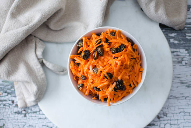 Grated Carrot Salad with Raisin in a White bowl