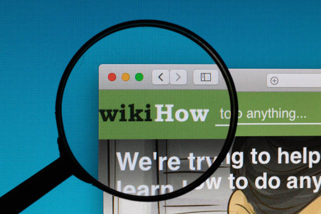 wikiHow logo under magnifying glass