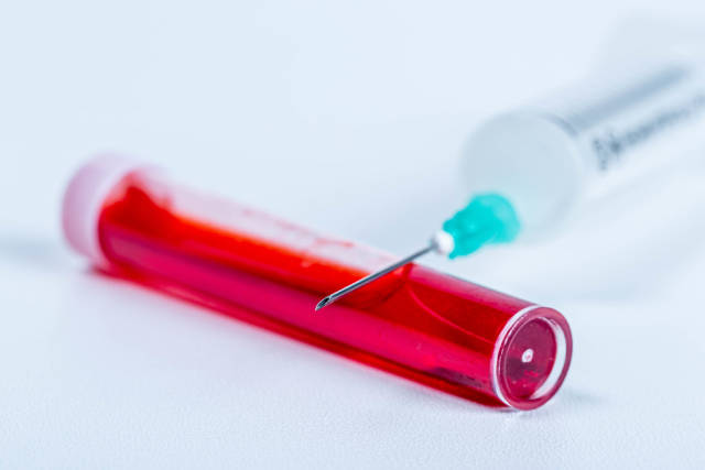 Test tube and syringe, close-up