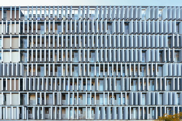 Modern looking building with multitude of panels over the facade in Amsterdam