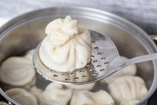 Close-up, cooked khinkali on a skimmer