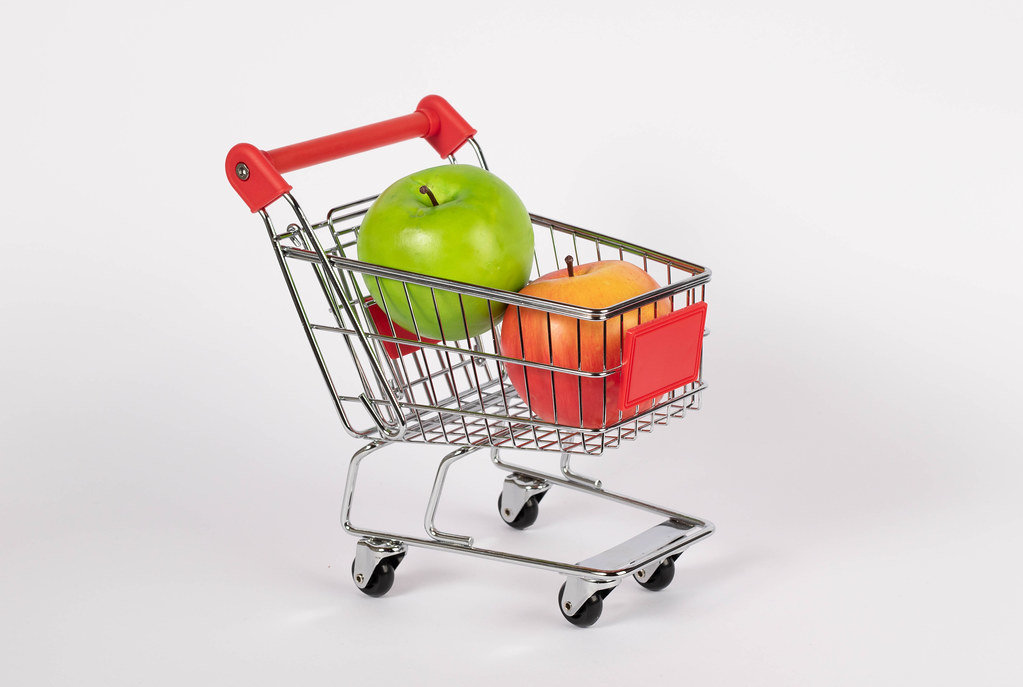 Shopping cart filled with fresh apples