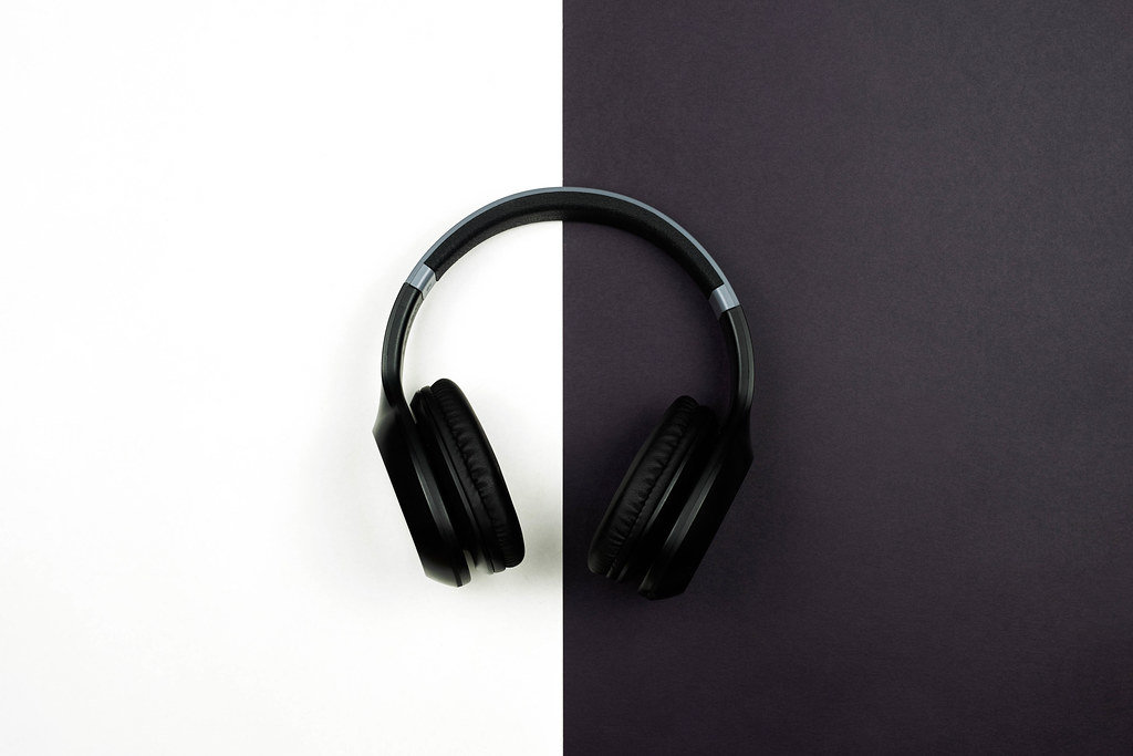 A wireless headphones on black and white split background