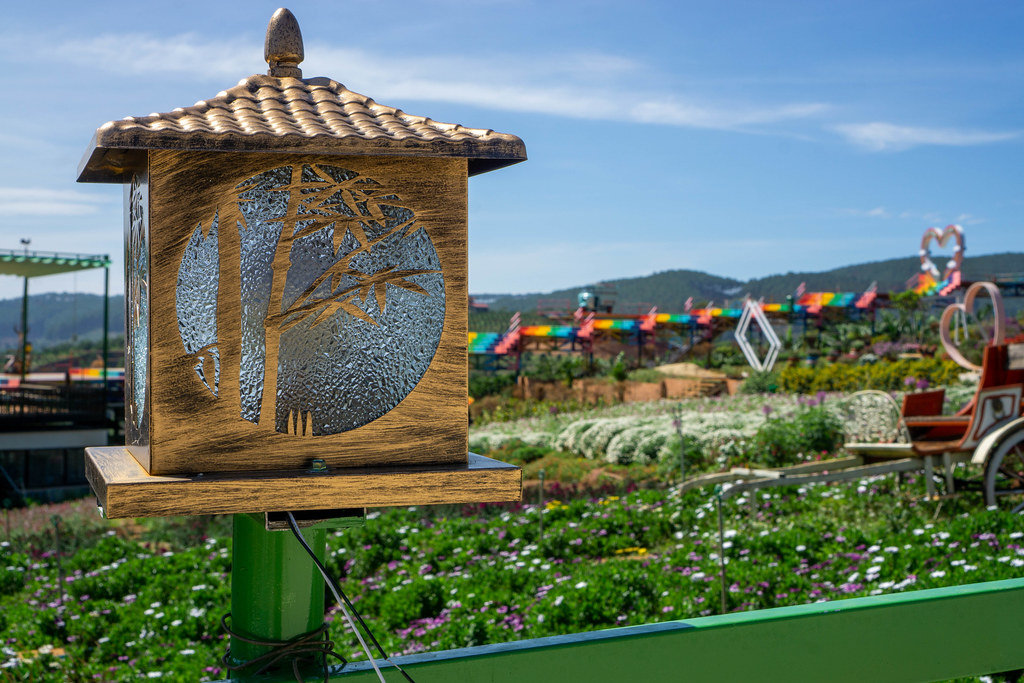 Close Up Photo of Wooden Electric Lantern with Flower Garden in the Background at Me Linh Coffee Garden in Dalat, Vietnam