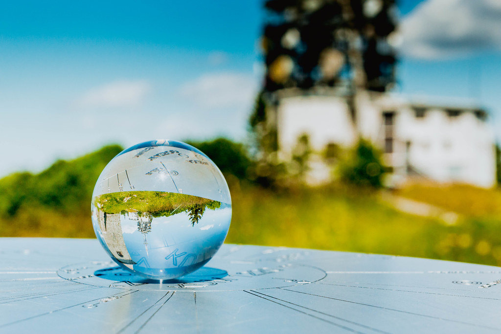 Church tower reflected in glass ball