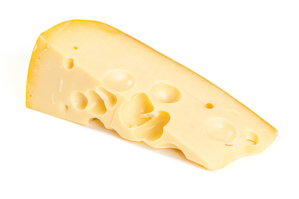 Maasdam cheese on white background