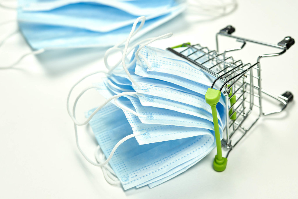 Face masks deficit concept - stack of surgical masks in shopping trolley