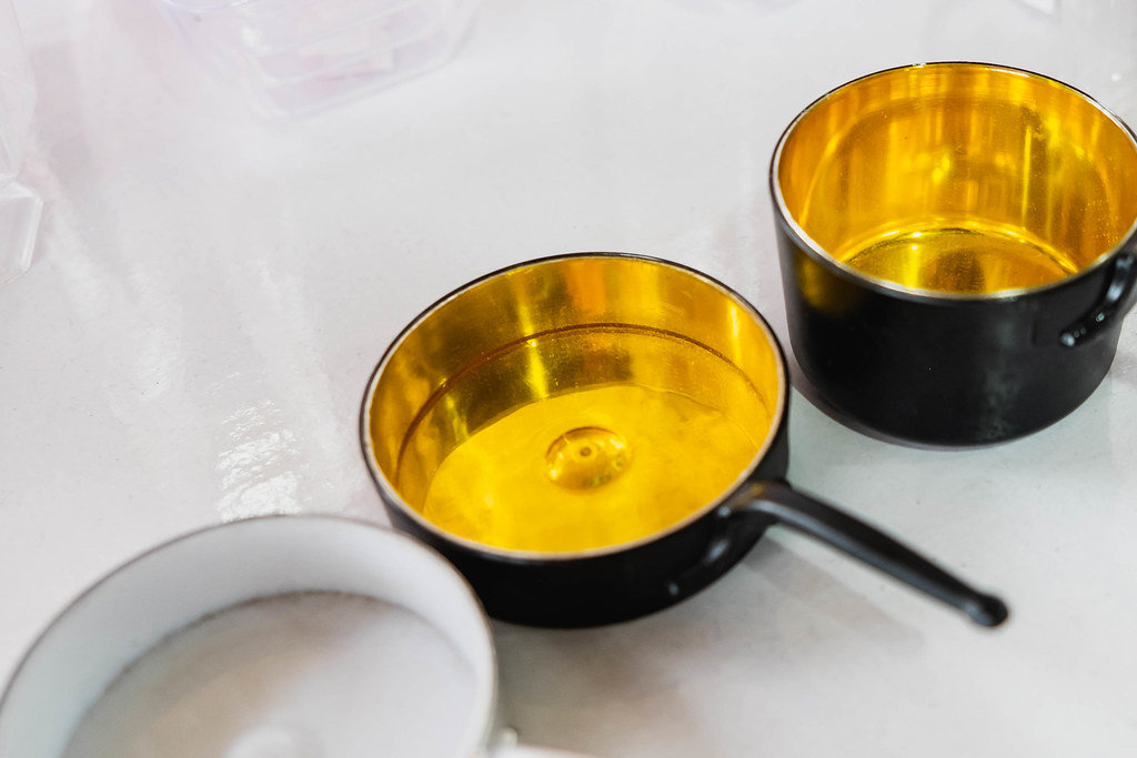 Miniature pans and pots on white surface