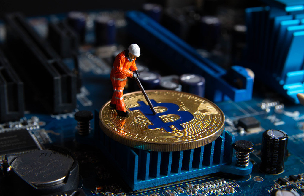 Miner working on a Bitcoin on computer motherboard