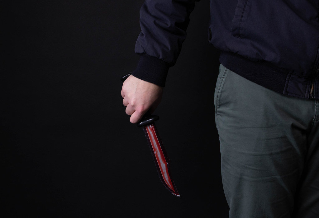 Male hand with bloody knife