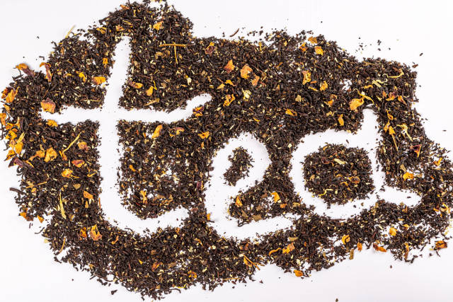 Tea inscription on the background of dried black tea