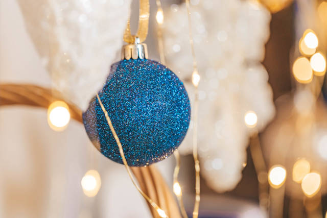 Close-up, blue ball on blurred christmas background