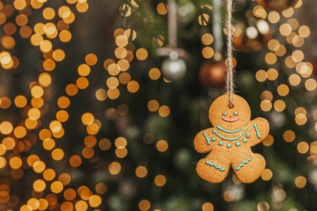 Gingerbread cookie man on golden christmas bokeh background