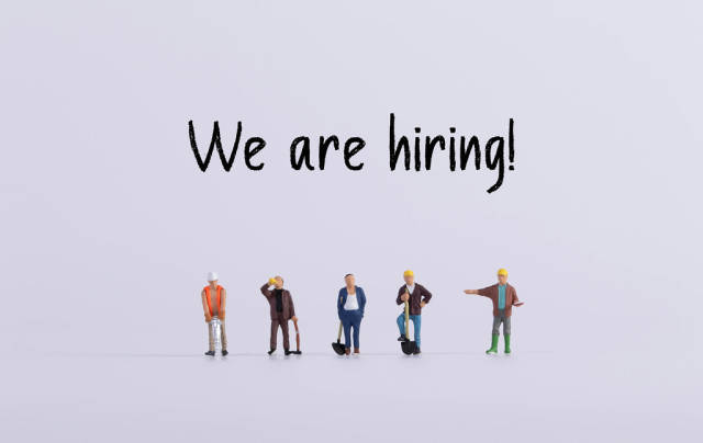 Group of workers with We are hiring text
