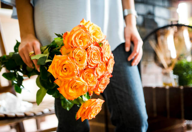 Girl holding orange roses