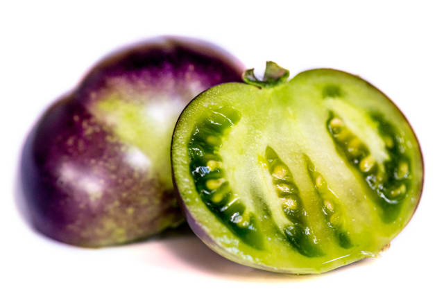Purple tomato halves with green pulp