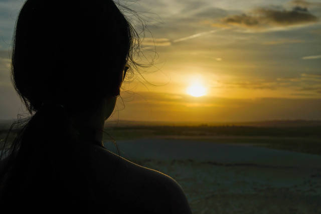 Person looking at the Sunset from a Mountain in the White Sand Dunes in Mui Ne
