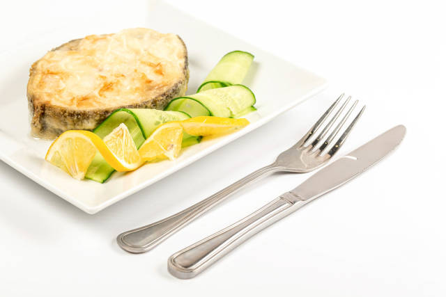 Fried escolar fish with lemon and cucumber