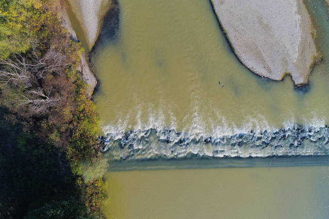 Aerial view of land and water, Arges river in Romania