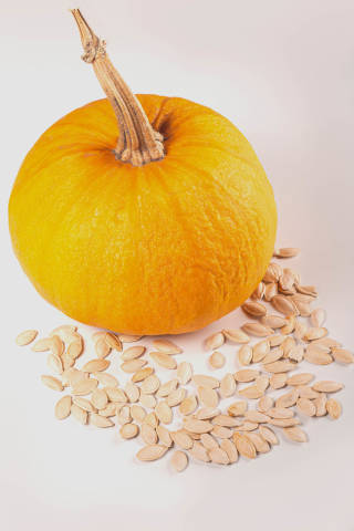 Ripe orange pumpkin with pumpkin seeds