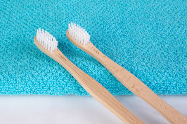 Wooden toothbrushes on towel