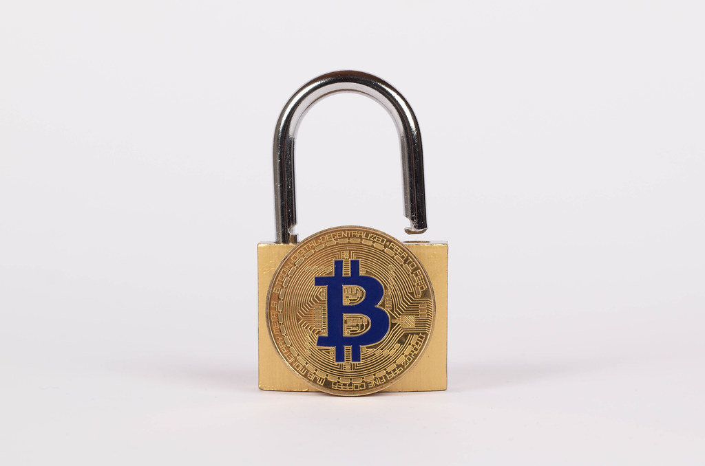 Padlock with golden Bitcoin on white background