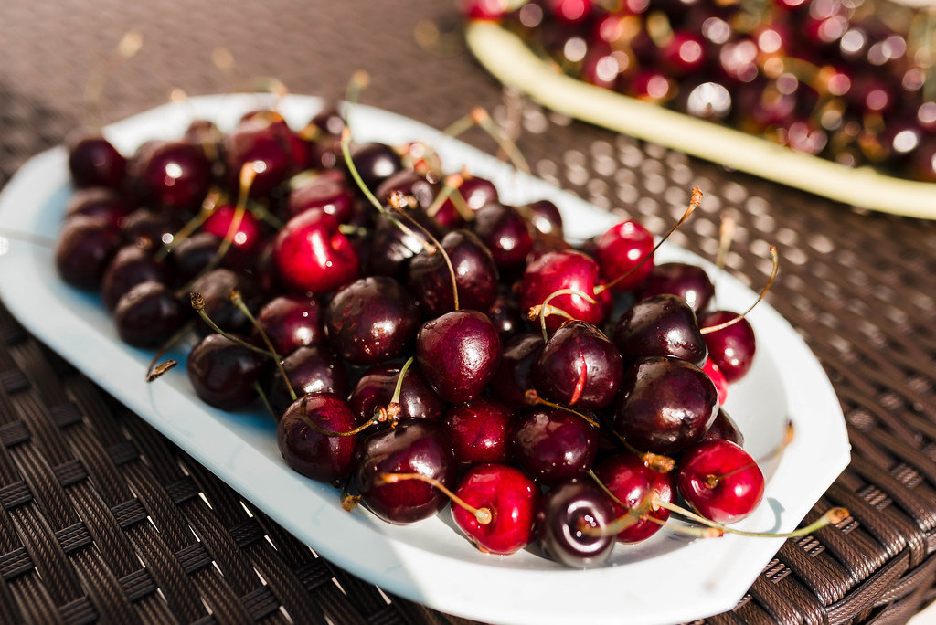 Big Red Cherries On The White Dish