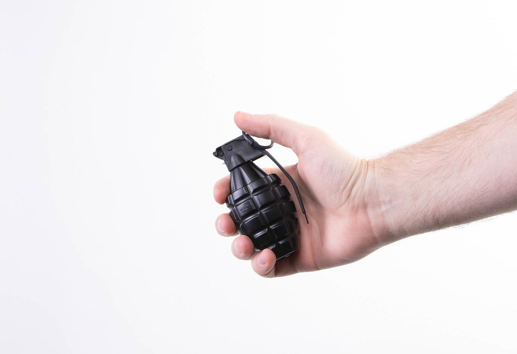 Hand holding hand grenade