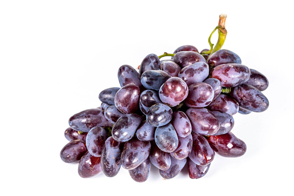 Velvet red grapes on white background