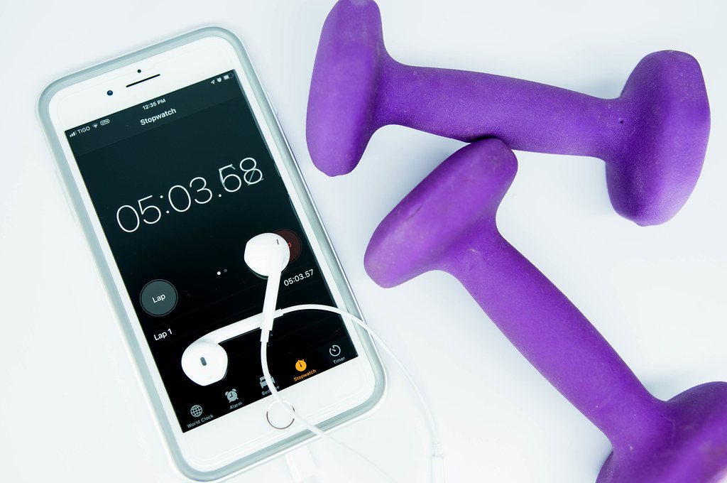 Two-pound weights and a running timer on an iphone